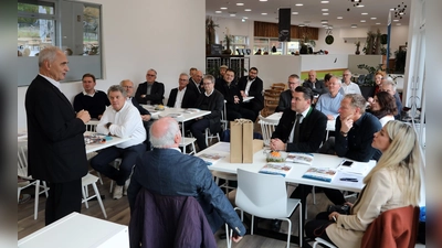 Alois Hagl (links), Vorsitzender des Vereins Partner für den Landkreis Schwandorf, heißt die Gäste beim 30. Wirtschaftsfrühstücks in der Erlebnisholzkugel am Steinberger See willkommen. (Bild: ggö)