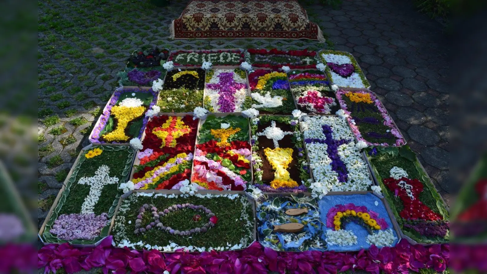 Gute Ideen sollten nicht im Archiv verstauben. Den Zeitungsartikel vom Hahnbacher Fronleichnamsteppich 2024 holte das Kindergruppenteam aus der Schublade und so entstand auch in Edelsfeld ein wunderschöner, bunter Blumenteppich in Pizzakartons. (Bild: Elfriede Winter)