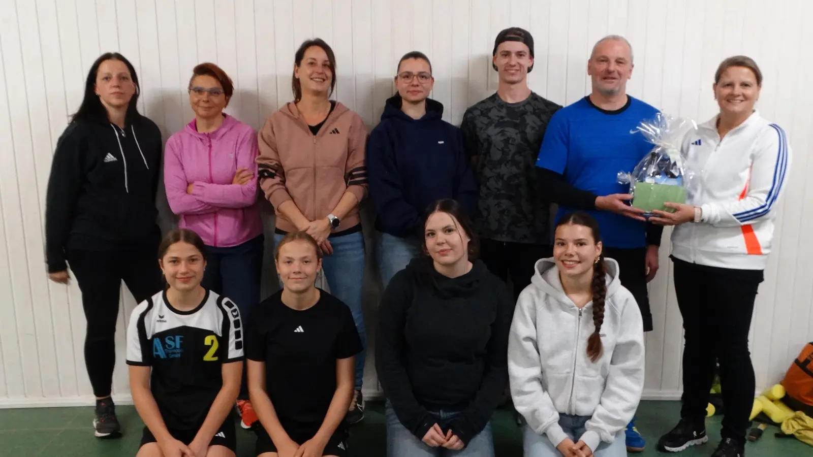 Die Kursteilnehmer und -teilnehmerinnen mit Übungsleiter Thomas Wegmann (hinten rechts), dem Vorsitzende Beate Sporrer (außen rechts) ein Präsent überreicht. (Bild: Tanja Wegmann)