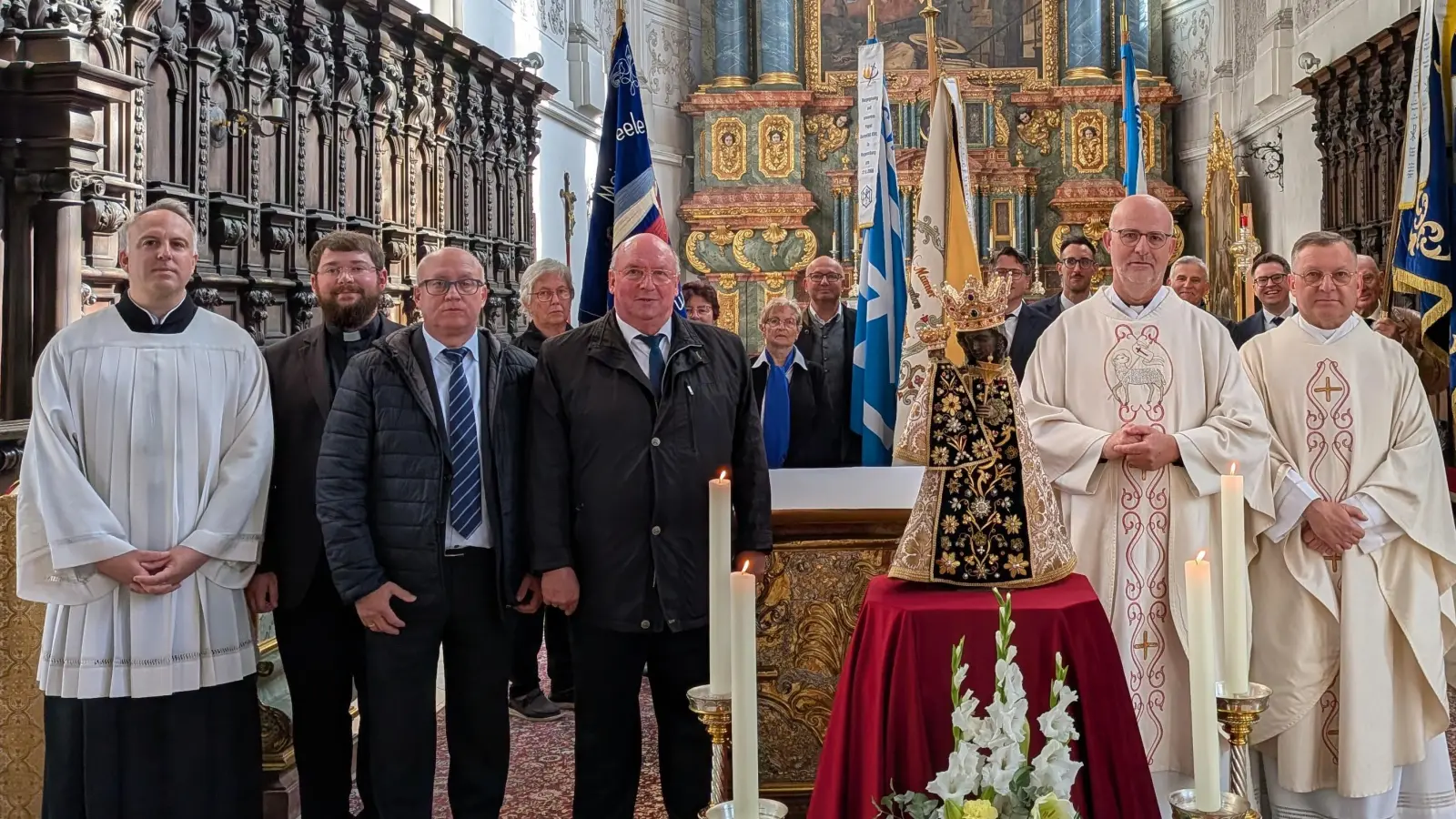 Das Gnadenbild umrahmt von (vordere Reihe von links) Assistent Christoph Halmich, Kaplan Klaus Schülein, Leiter Marienwerk Josef Herrmann, Präfekt Michael Koller, Marienwerk-Vorsitzender Pfarrer Christian Kriegbaum, Zentralpräses Stadtpfarrer Markus Brunner, dahinter die Fahnenabordnungen (Bild: Michael Koller junior)