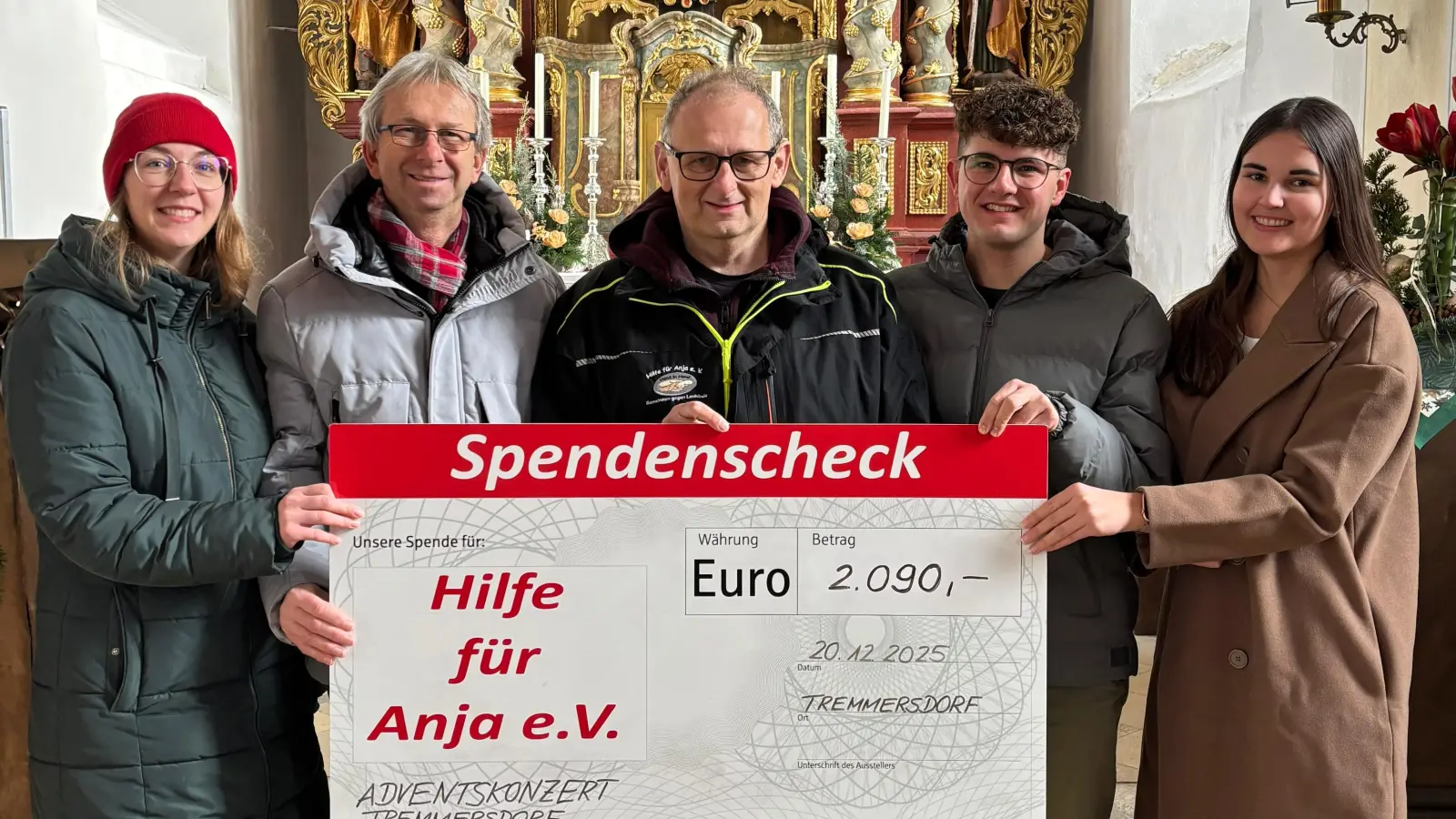 Eva zeitler (li), Christian Gebhardt (2.v.li.) als Organisator des Glühwein- und Bratwurststandes, Elias Rodler (2.v.re.) und Antonia Reiß (re) überreichten An „”Anja”-Vorsitzenden Michael Sporrer (Bildmitte) den symbolischen Spendenscheck.  (Bild: Robert Dotzauer)