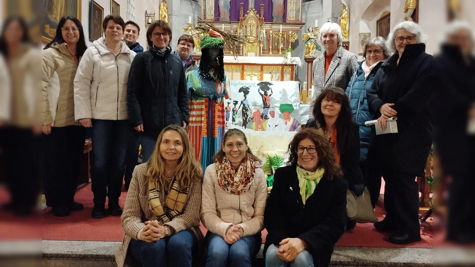 Der eigens für den Weltgebetstag gebildete Projektchor unter der Leitung von Birgit Kneidl (stehend, 3. v. l.) vor dem dem passend zum Motto gestalten Altar in der Pfarrkirche Kastl. (Bild: Eva Hoffmann)