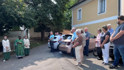 Pfarrer Emmanuel Okoro (Zweiter von links) segnete nach dem Sonntagsgottesdienst in Unterauerbach die Fahrzeuge und alle, die sie im Straßenverkehr nutzen. (Bild: Franz Grabinger)
