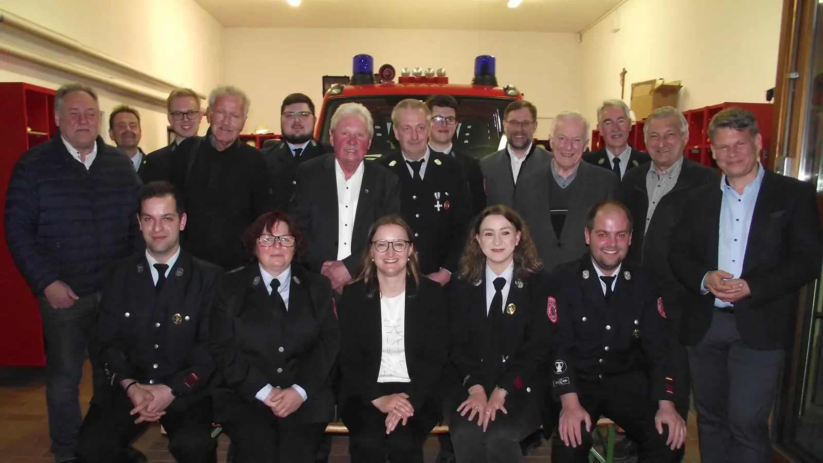 Sieglinde Fleischmann (sitzende 2. v. links) übergab in der Jahresversammlung der Muglhofer Werhr den Führungsstab an ihren Sohn Thomas (stehend dahinter, 5. v. links) ab. Mit im Bild die weiteren gewählten Vorstandsmitglieder, Geehrte und politische Vertreter.  (Bild: Robert Ronke)