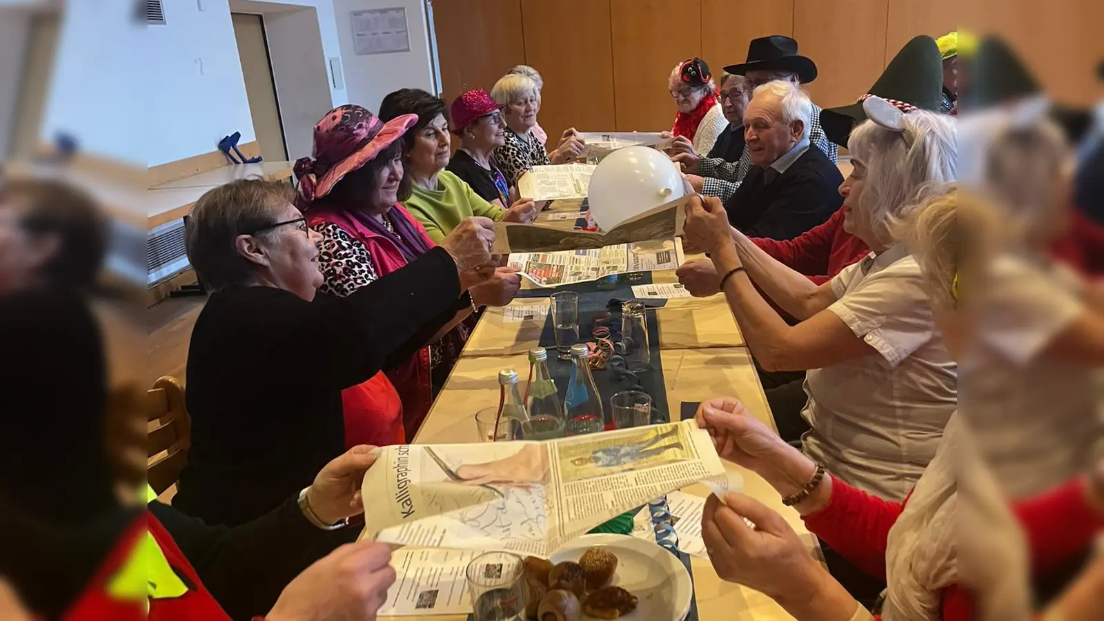 Die Senioren beim Luftballonwerfen im Wettstreit mit den anderen Tischreihen (Bild: Bernadette Oppl)