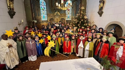 Pfarrer Emmanuel Okoro (links) sandte die rund 60 Sternsingerinnen und Sternsinger nach dem Gottesdienst in der Pfarrkirche Unterauerbach in die Häuser der Pfarreien, um den Segen für das neue Jahr zu bringen. (Bild: Franz Grabinger)