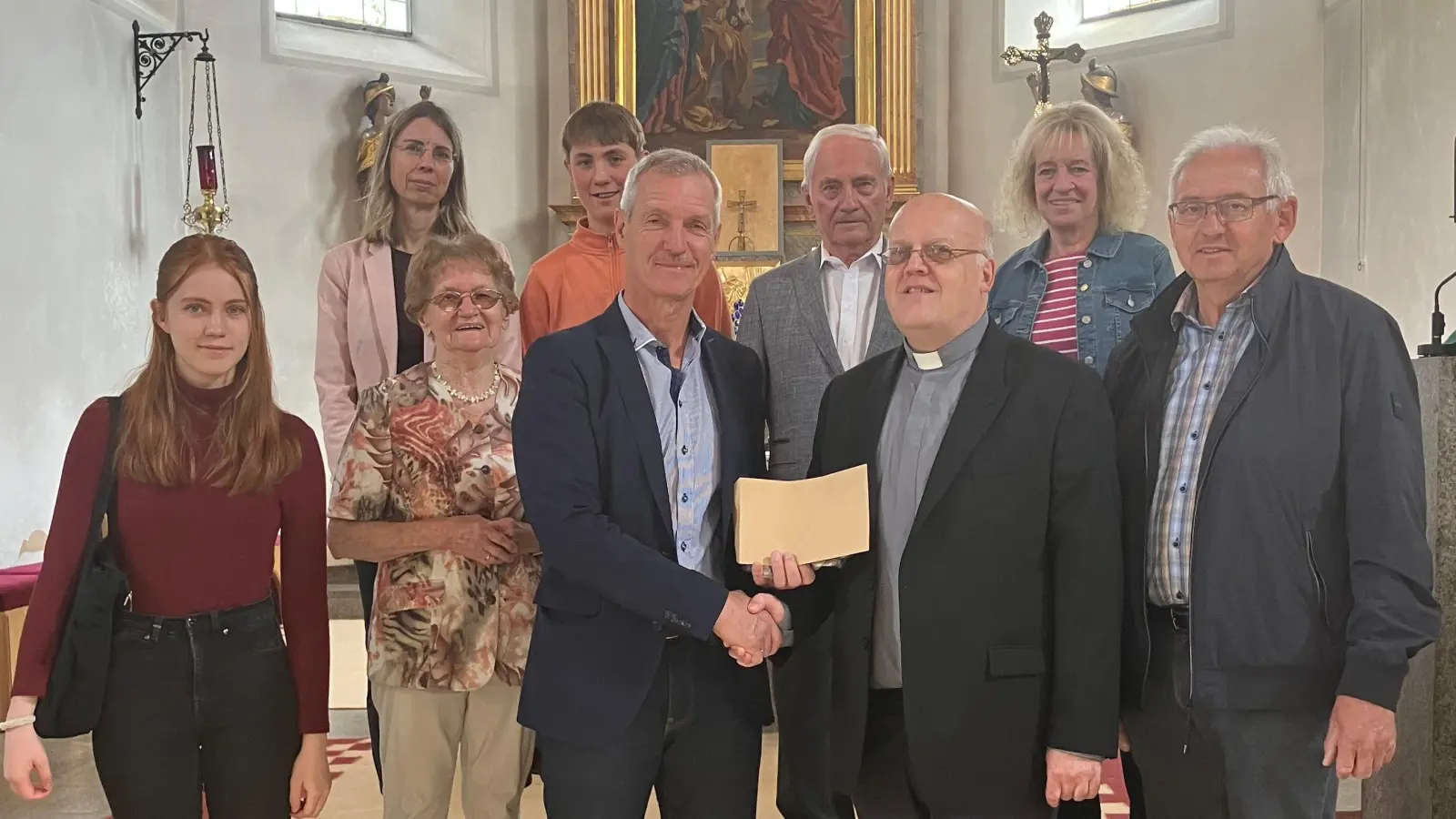 Kirchenpfleger Josef Völkl überreichte Pater Dariusz eine Spende der Pfarrei (Bild: Sonja Sczech)