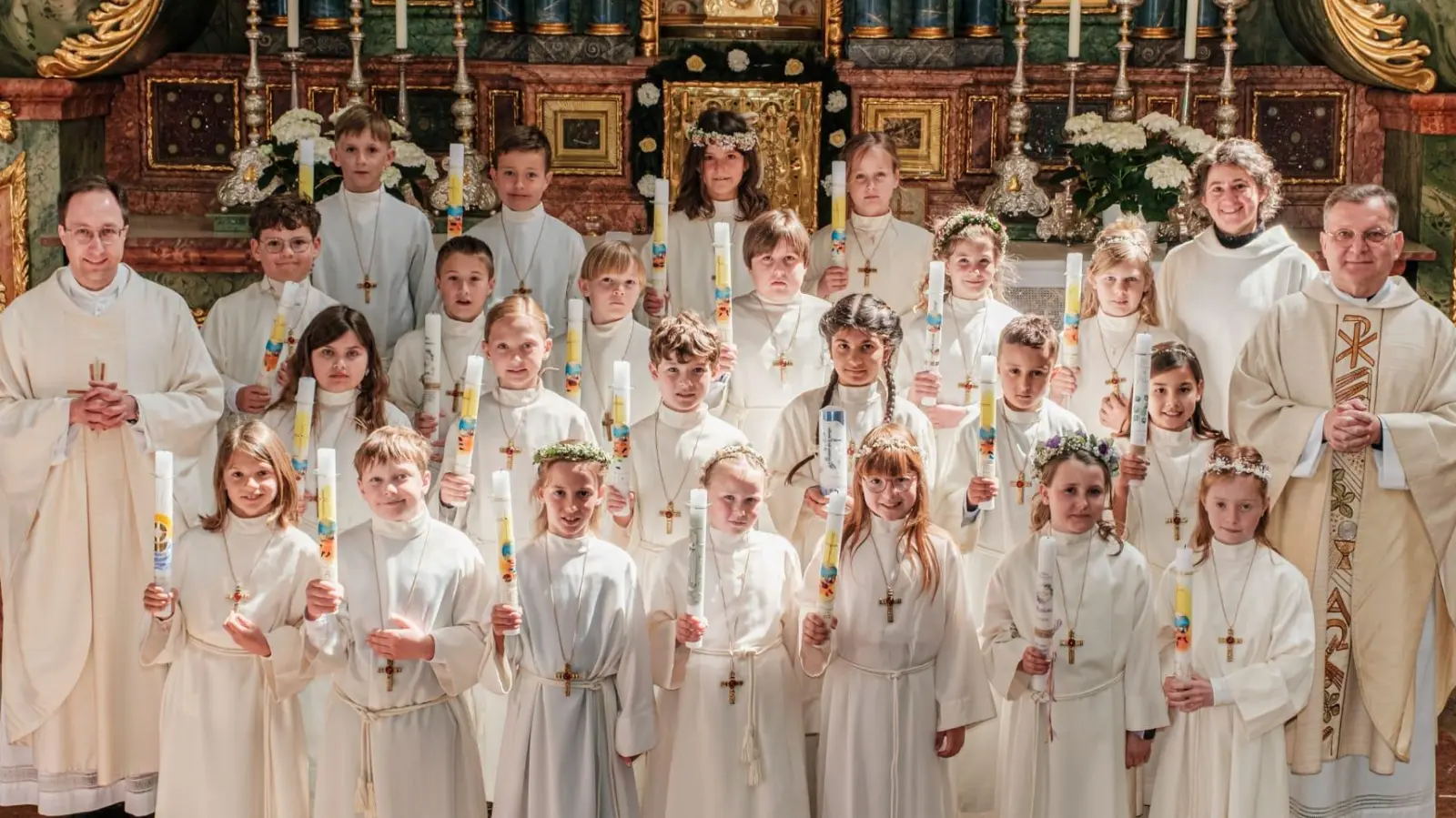 Die 23 Erstkommunionkinder in St. Georg Amberg mit Kaplan Johannes Spindler (links), Gemeindereferentin Gabriele Papp und Stadtpfarrer Markus Brunner (rechts) (Bild: Günter Scharl)