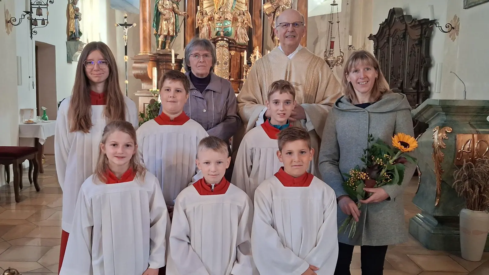Unten von links: Magdalena Ziereis, Kilian Betz und Johannes Forster. Mittlere Reihe von links: Oberministrant Manuel Forster, Elias Wicki und Mini-Betreuerin Frau Erika Biegerl. Obere Reihe: Oberministrantin Johanna Betz, Mesnerin Frau Maria Kühner und Pfarrer Herbert Rösl (Bild: Herbert Rösl)