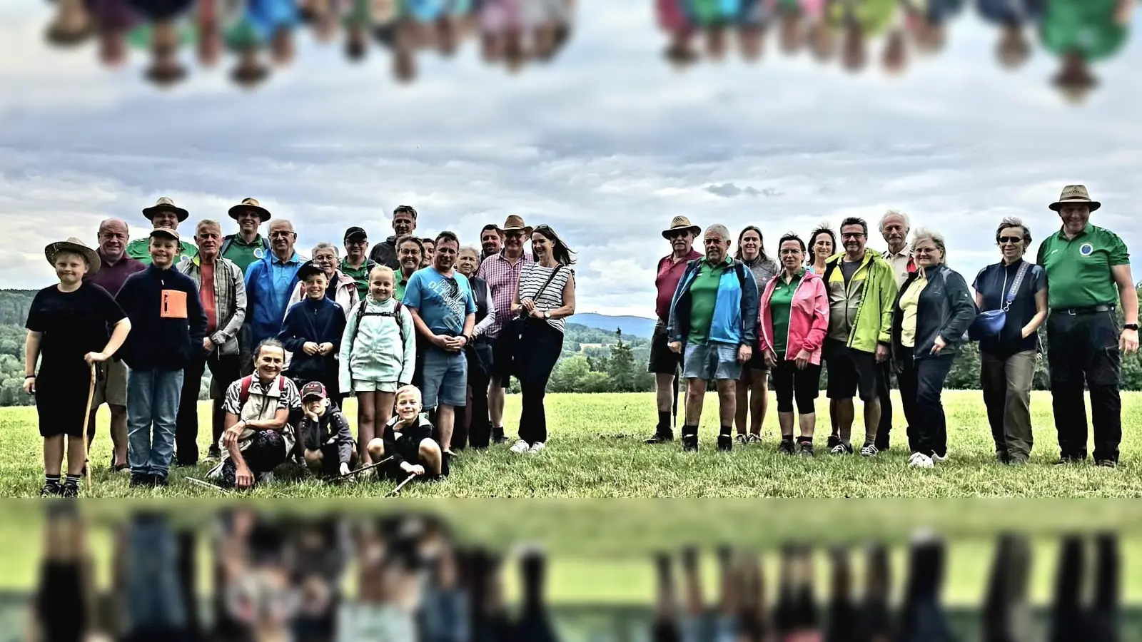 Die Wandergruppe um Wanderwart Hubert Ach (Erster von rechts) beim Start in Steinlohe. Im Hintergrund in der Bildmitte ist der Bergrücken leicht zu sehen, auf dem die beiden NATO-Türme des Hohen Bogens stehen. (Bild: Peter Kirner)