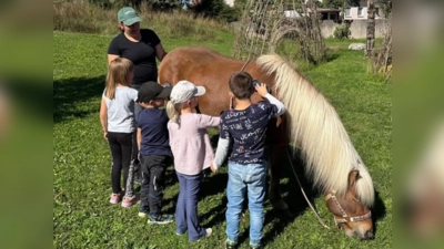 Die Kinder putzen mit Striegel und Kardätsche Dagfari, der sich das Gras im Garten des Kinderhauses St. Barbara schmecken lässt. (Bild: Andrea Stadler)
