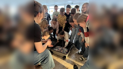 Schüler beim Öffnen des Koffers mit den Lektüren. (Bild: Simone Völkl)