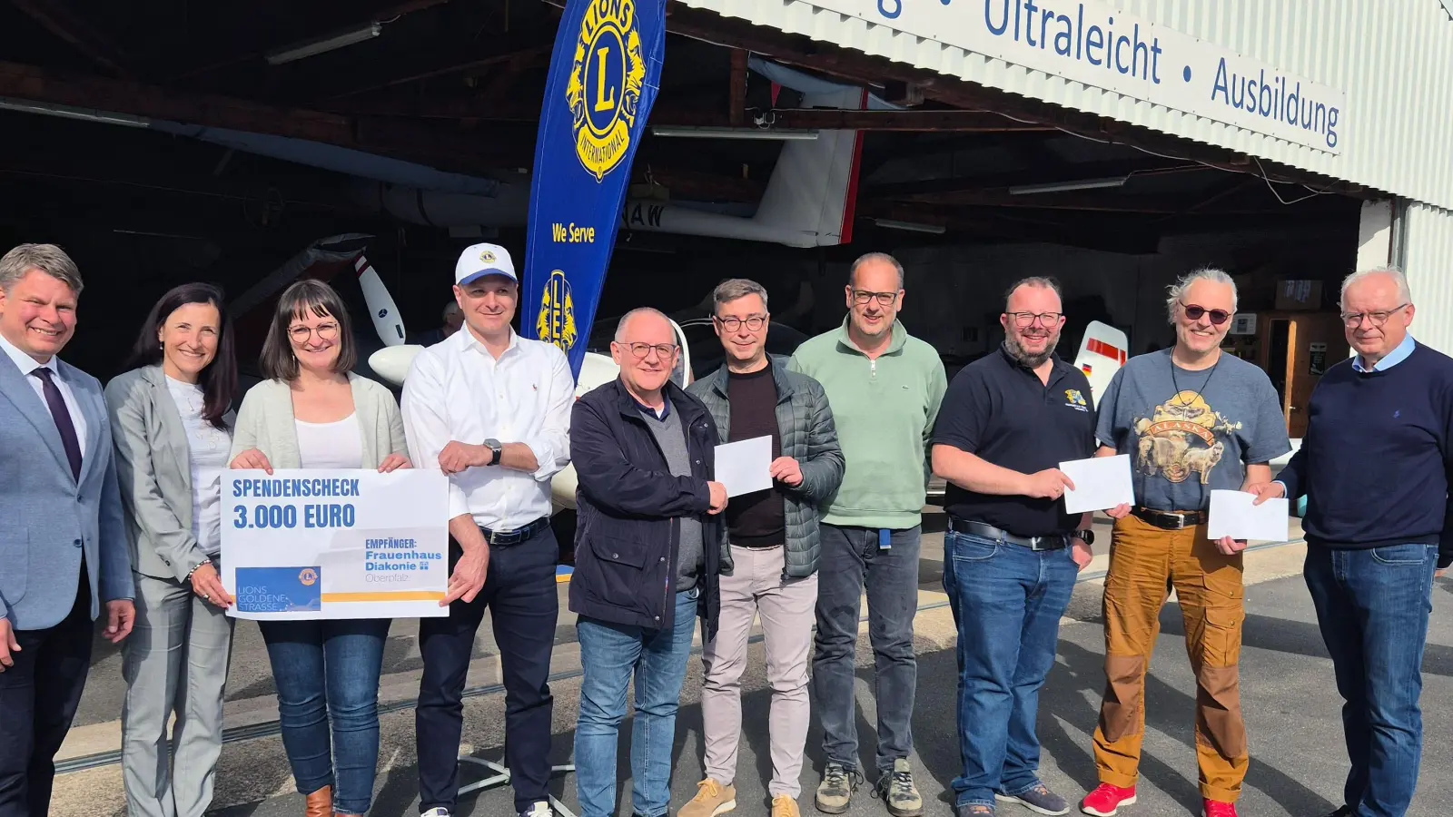 Spendenübergabe in Latsch mit Oberbürgermeister Dr. Benjamin Zeitler (von links), Tanja Schiffmann (Lions Weiden-Goldene Straße), Enikö Nagy (Frauenhaus), Christoph Müller-Rauch (Lions Weiden-Goldene Straße), Dr. Elmar Baumer (Lions Weiden), Stephan Schindler (TB Weiden), German Schieder (TB Weiden), Sebastian Denzler (Lions Neustadt), Michael Richthammer (Magisches Projekt), Dr. Franz Wach (Lions Weiden). (Bild: Alexander Kießlich)