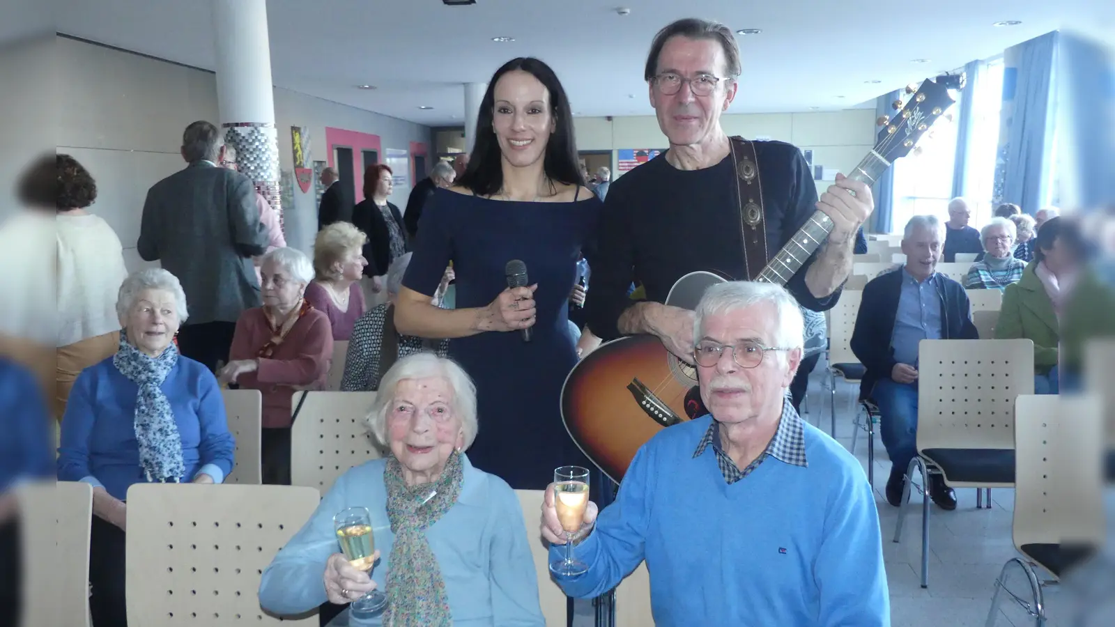 Die 100-jährige Justine Hupp (mit Sohn Wolfgang) waren Ehrengäste beim Konzert „Runde Geburtstage und Ehejubiläen 2025” der Stadt Eschenbach. Das Akustikduo „Tunes For Two” mit Johanna Gerber und Andreas Demleitner gratulierte nachträglich.  (Bild: Walther Hermann)