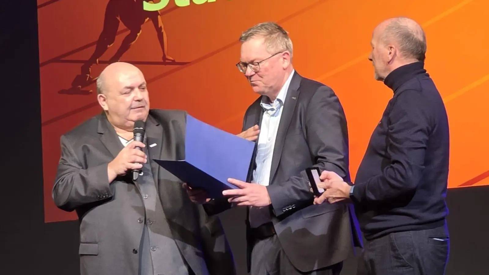 Bei der Sportlerehrung der Stadt Amberg überraschten der Vorsitzendes des Bayerischen Landessportverbandes Thomas Gebele (li) und der Vorsitzende der Bayerischen Sportjugend Reinhard Weber (re) Oberbürgermeister Michael Cerny (mittig) mit einer der höchsten Ehrungsstufe der Verdienstplakette in Gold für sein Engagement um den Amberger Sport. (Bild: Thomas Gebele )