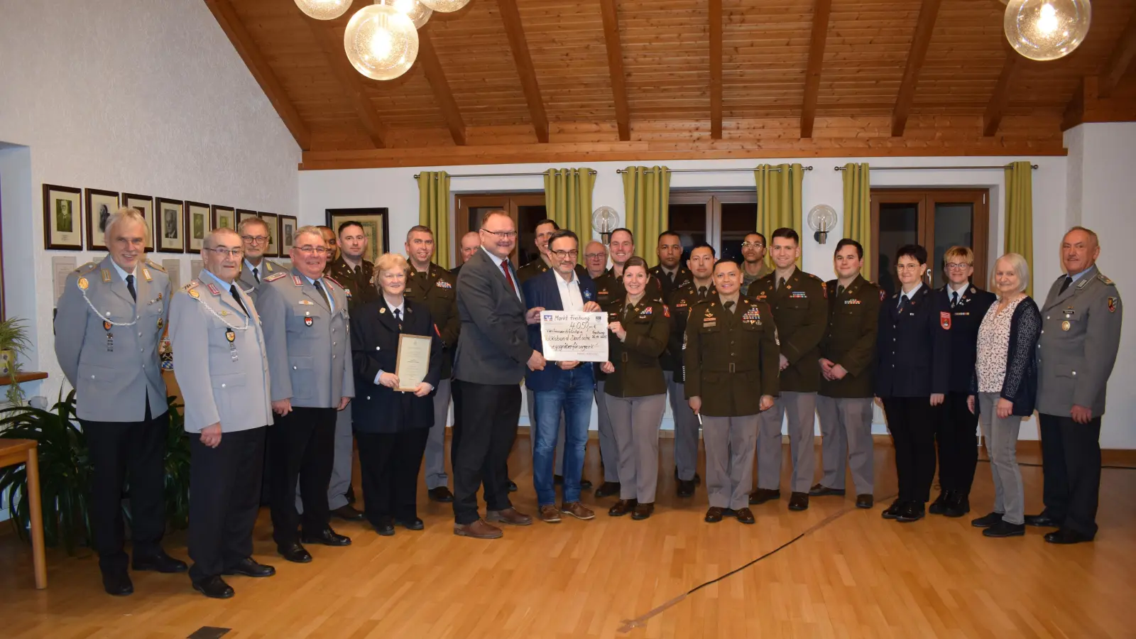 Bei der Spendenübergabe im Freihunger Rathaus übergaben die Führungskräfte der US-Partnerverbände von der 18. CSSB und 702. EOD mit den Sammlern der Reservistenkameradschaft und Feuerwehren insgesamt etwas mehr als 4 200 Euro Spendengelder an den Volksbund Deutsche Kriegsgräberfürsorge. <br>(In der Mitte des Bildes) Bürgermeister Uwe König (9. v. links) übergibt zusammen mit der neuen Kommandeurin, Lieutenant Colonel Michelle Updike (11. v. links), symbolisch einen Spendenscheck an den Geschäftsführer des Bezirksverbandes Oberpfalz, Dr. Dario Vidojkovic (dazwischen). <br>Mit im Bild (4. v.links) Sammlungsleiter Oberstleutnant d.R. Norbert Bücherl und (rechts) Oberstleutnant d.R. Werner Gebhard (Ehrenkreisvorsitzender Verband der Reservisten der Deutschen Bundeswehr, Kreisgruppe Oberpfalz-Mitte). Dazwischen die ehrenamlichen Sammler und die Kompaniechefs und Kompaniefeldwebel der US-Einheiten. <br> (Bild: Nathalie Simmel, US-Armee, Public Affairs)