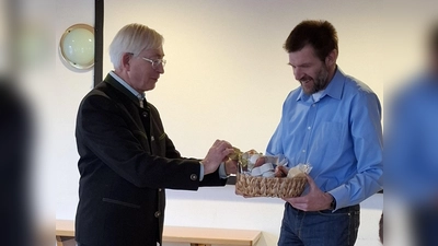 Zweiter Vorsitzender Karl Meier bedankt sich mit einem Korb regionaler Spezialitäten (Bild: Bernhard Thöresz)