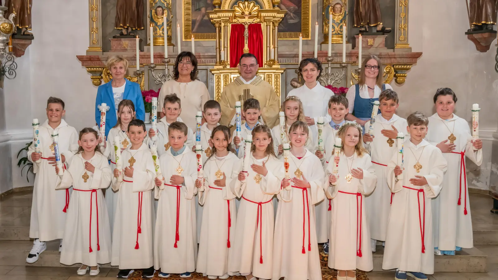 Gruppenbild der 17 Erstkommunionkinder mit Stadtpfarrer Konrad Amschl, Pastoralreferentin Maria Wagner, Praktikantin Verena Völkl und den Lehrkräften Birgit Zant und Marianne Schmid (Bild: ws-fotografie)
