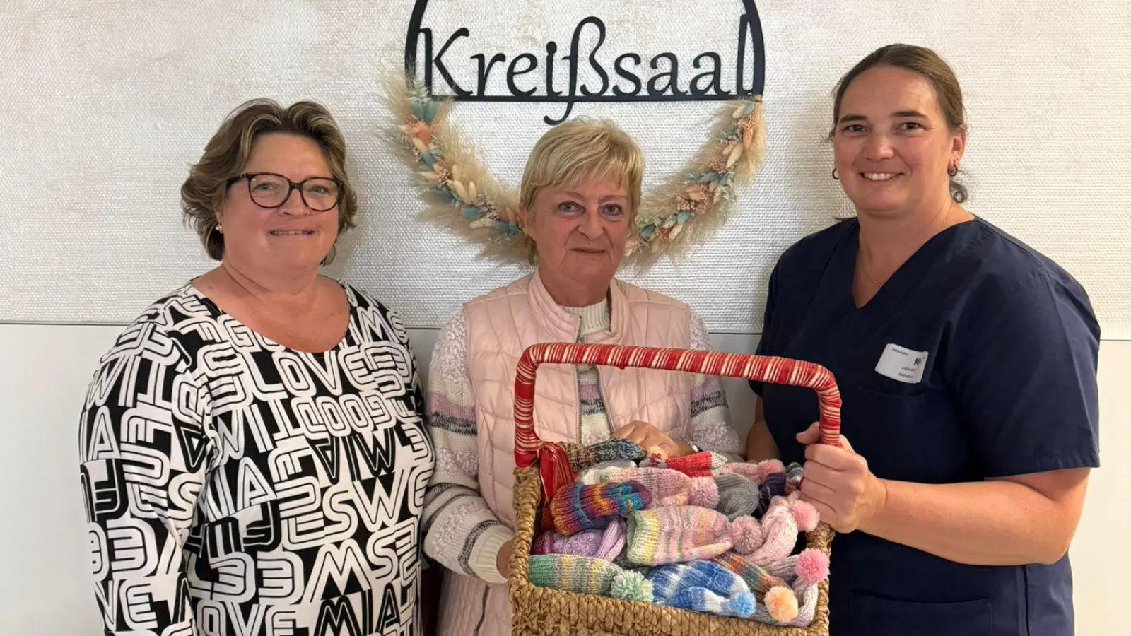 Doris Schwab und Renate Siegel (von links) von der Strickrunde Neustadt/WN übergaben an Hebamme Julia Witt 120 bunte Babymützchen für Neugeborene.  (Bild: Julia Witt)