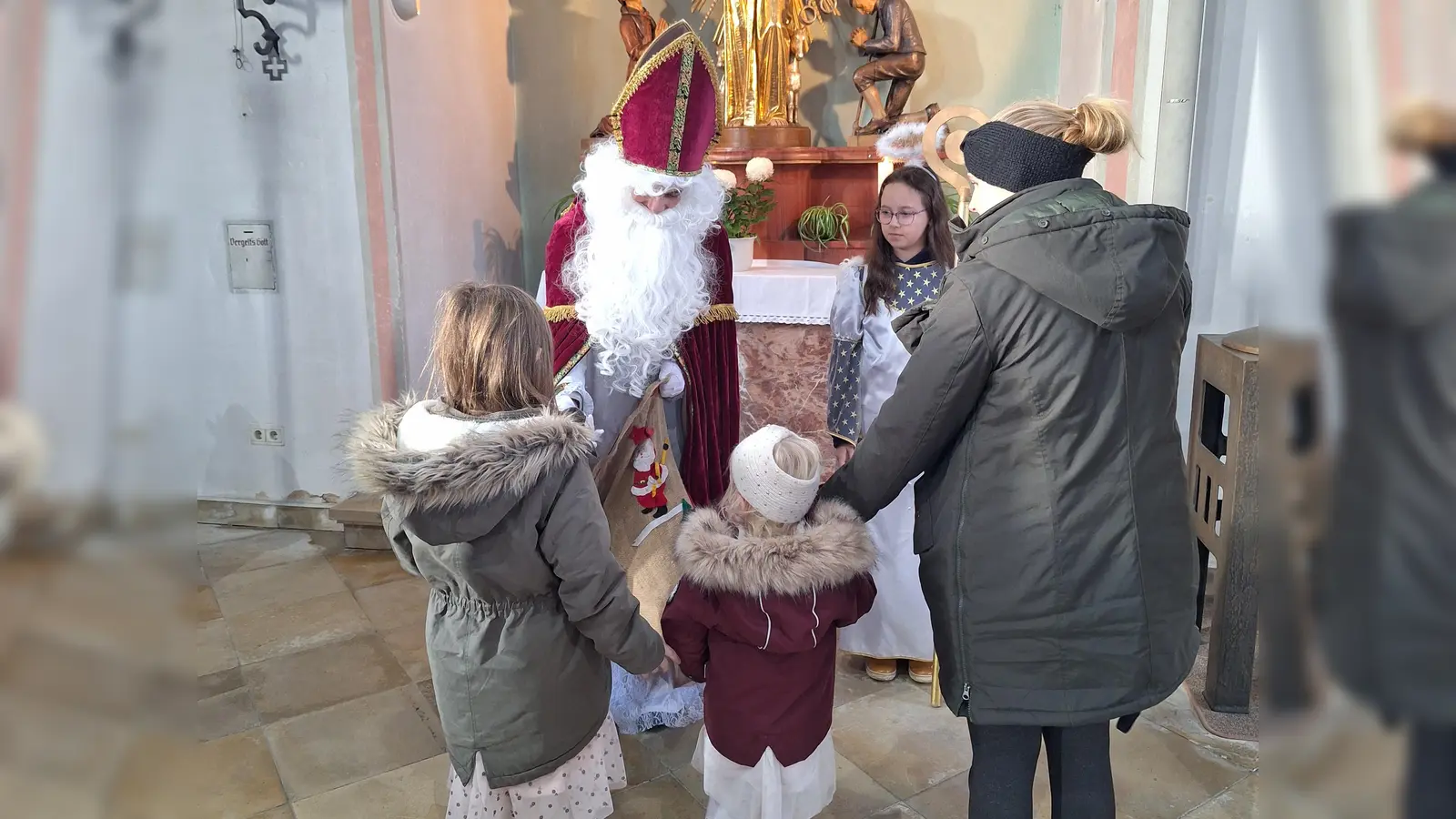 Der Heilige Nikolaus beschenkt die Kinder. (Bild: Elfriede Schwarzmeier)