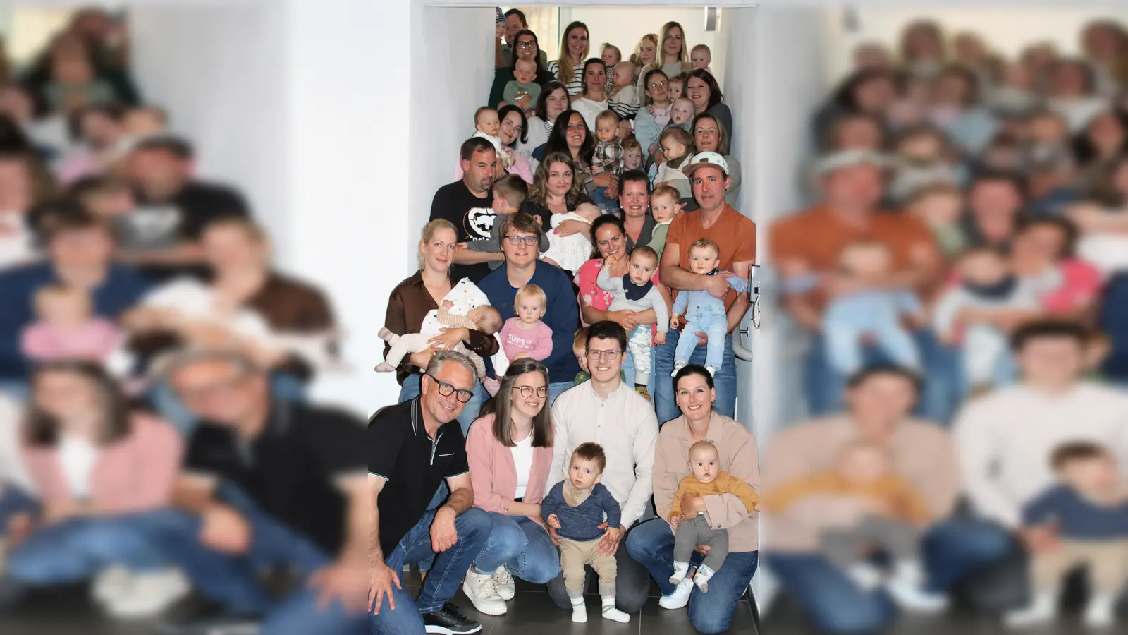 Das Treppenhaus des Rathauses Poppenricht war fast zu klein für die vielen Familien. Gemeinsam mit ihren Eltern versammelten sich die neugeborenen Kinder zum Gruppenfoto mit Bürgermeister Hermann Böhm (vorne links). (Bild: Regina Schatz)