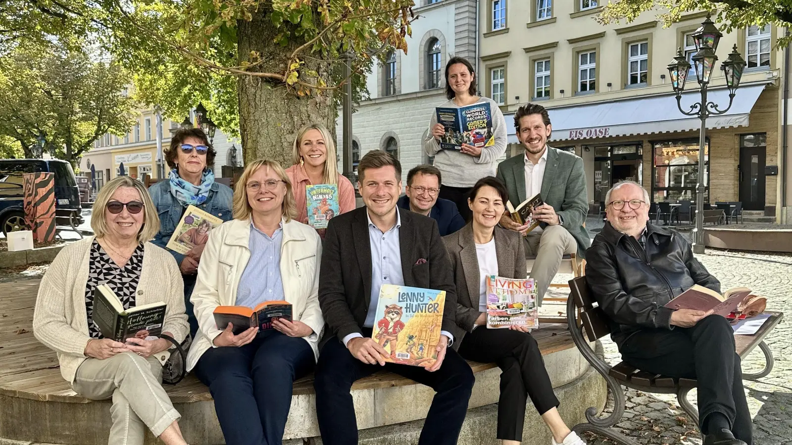 Erster Bürgermeister Nicolas Lahovnik (Mitte) freut sich mit Vertreterinnen und Vertretern der Stiftungen, Vereine und Institutionen über die neuen Rabatten am Marktplatz. Auf dem Foto (von links): Angelika Wellenhöfer (Heinrich-Benno-Schäffler-Stiftung), Birgit Pöhlmann (Aktive Bürger Wunsiedel), Manuela Menkhoff (Vorsitzende Aktive Bürger Wunsiedel), Generationenbürgermeisterin Carolin Kammerer (Bürgerstiftung), Michael Maurer (stellv. Vorstandsvorsitzender Sparkasse Hochfranken), Angela Schwarz (Heinrich-Benno-SchäfflerStiftung und Vorsitzende WUN Immobilien KU, vorne), Jana Bachmann-Schaidinger (Leiterin Stadtbücherei), Daniel Wolf (Geschäftsleitender Beamter) und Pfarrer Günter Vogl (HeinrichBenno-Schäffler-Stiftung). (Bild: Kristina Wiedel)