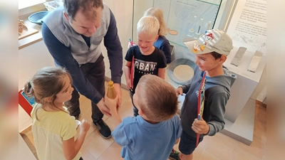 Wissen greifbar machen: Der Vergleich mit drei unterschiedlich gefüllten Flaschen (Wasser, Erde, Gold) sorgt für staunende Gesichter – Gold ist überraschend schwer! (Bild: Tanja Schlehuber)