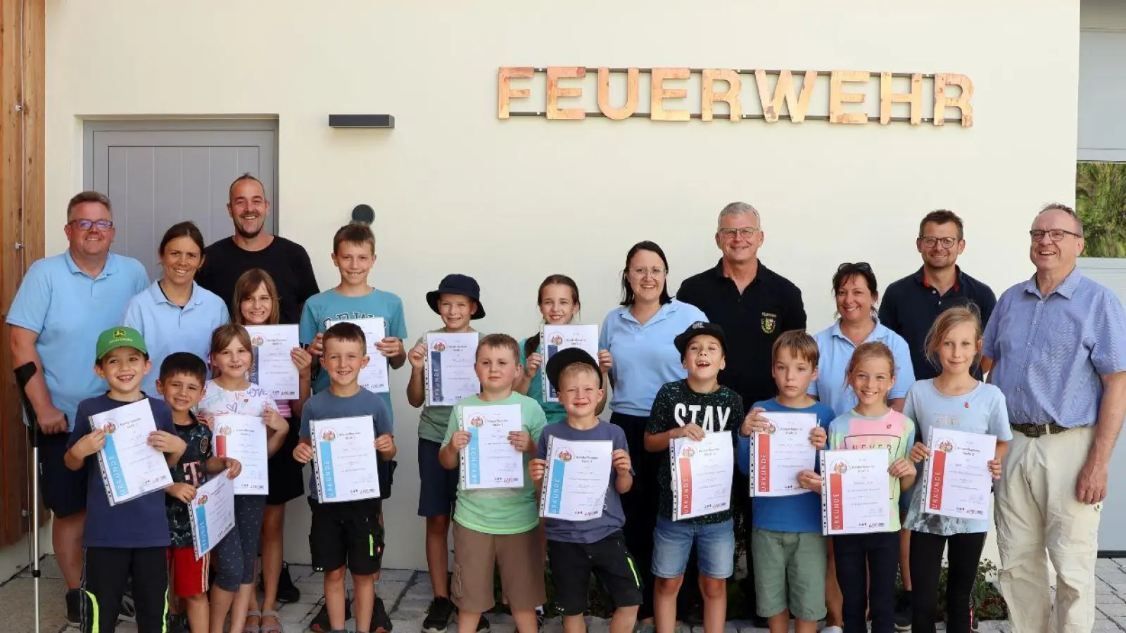 Alle sind zufrieden mit der gelungenen Abnahme der Kinderflamme. Hinten von links nach rechts: Markus Rauscher, Claudia Graf, Matthias Köstler, Melanie Pyka, Harald Schmidt von der Kreisbrandinspektion, Jenny Winklmann, Daniel Weiß, Kommandant Reinhard Bauer und natürlich der Feuerwehr-Nachwuchs der Kinderfeuerwehr Adlholz. (Bild: Markus Rauscher )