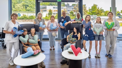 AG-Leiterin Rosi Zinkl (5. von links() und die pädagogische Fachkraft Christine Haider (4. von links) begleiteten die Schülerinnen der Telemann-Schule zur Übergabe der Herzkissen ins Krankenhaus der Barmherzigen Brüder in Schwandorf. (Bild: Michael Vogl)
