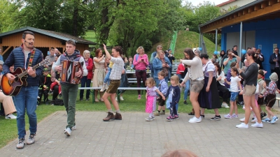 Bene und Ferdi ziehen voran und alle folgen beim Einzug zum Start in das Maifest. (Bild: Nikolaus Scherr)