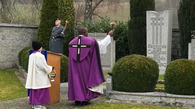 Pfarrer Emmanuel Okoro gedachte der Toten der Weltkriege und segnete das Ehrenmal am Unterauerbacher Friedhof. Die SKK Auerbachtal hatte die Feier vorbereitet. (Bild: Franz Grabinger)